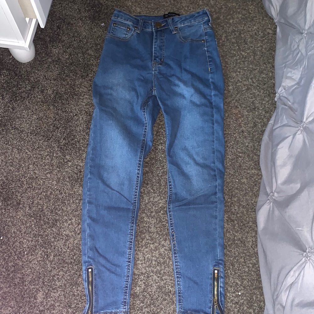 medium wash jeans with accent zipper on the ankle